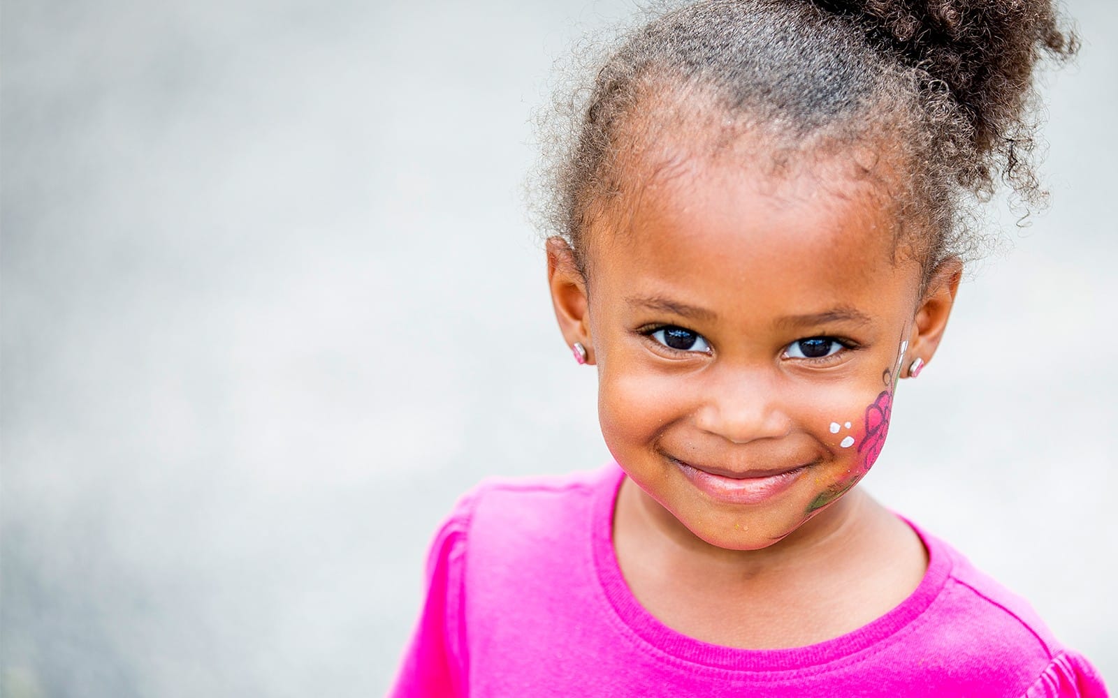 Little girl with facepaint on cheek