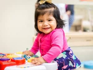 Little girl playing with toy