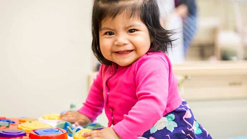 Little girl playing with toy