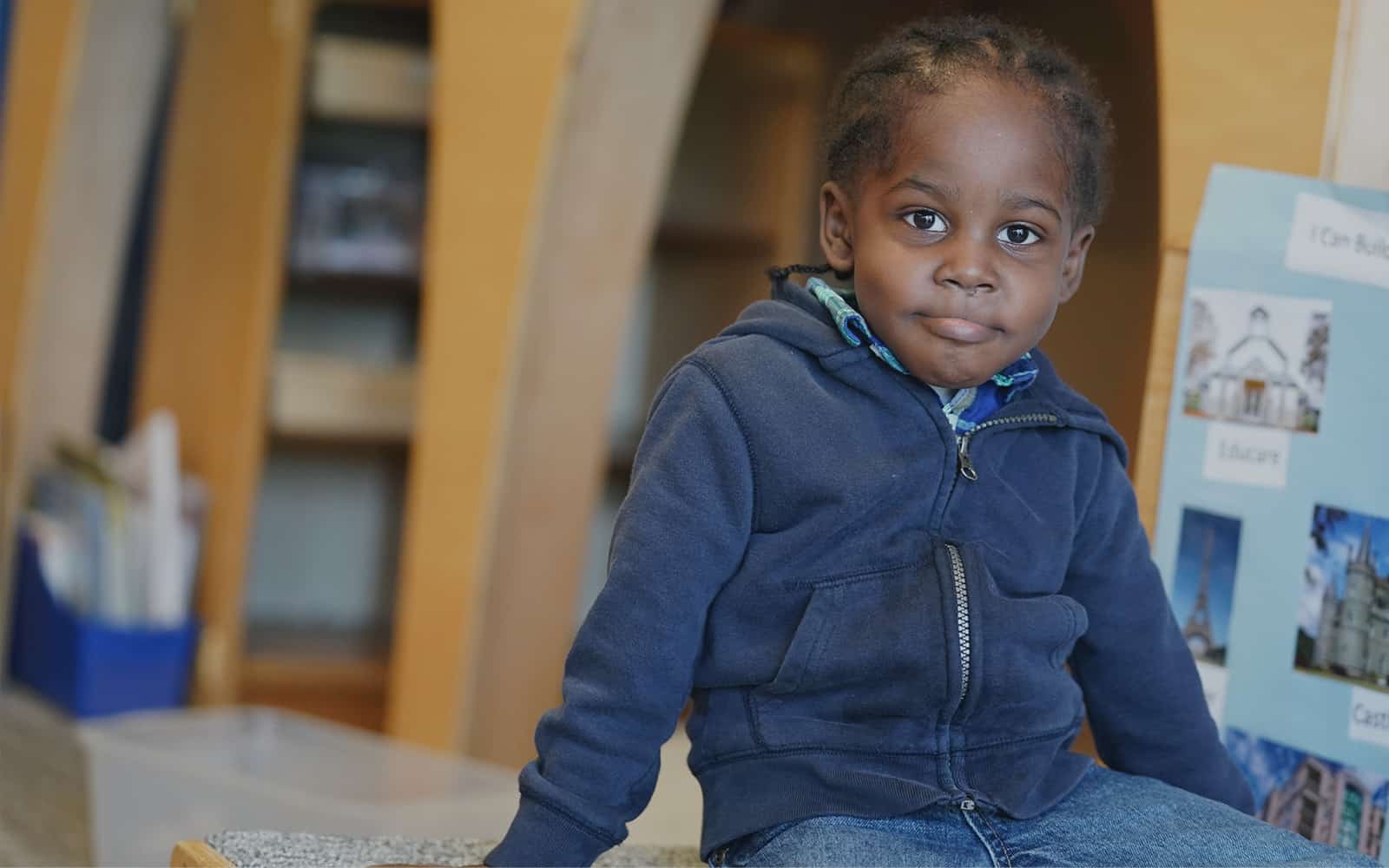 Educare Chicago student sitting on table