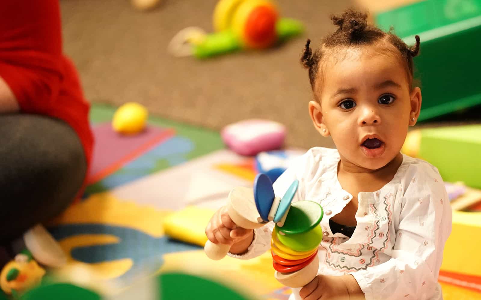 Baby girl playing with toy at Educare Chicago