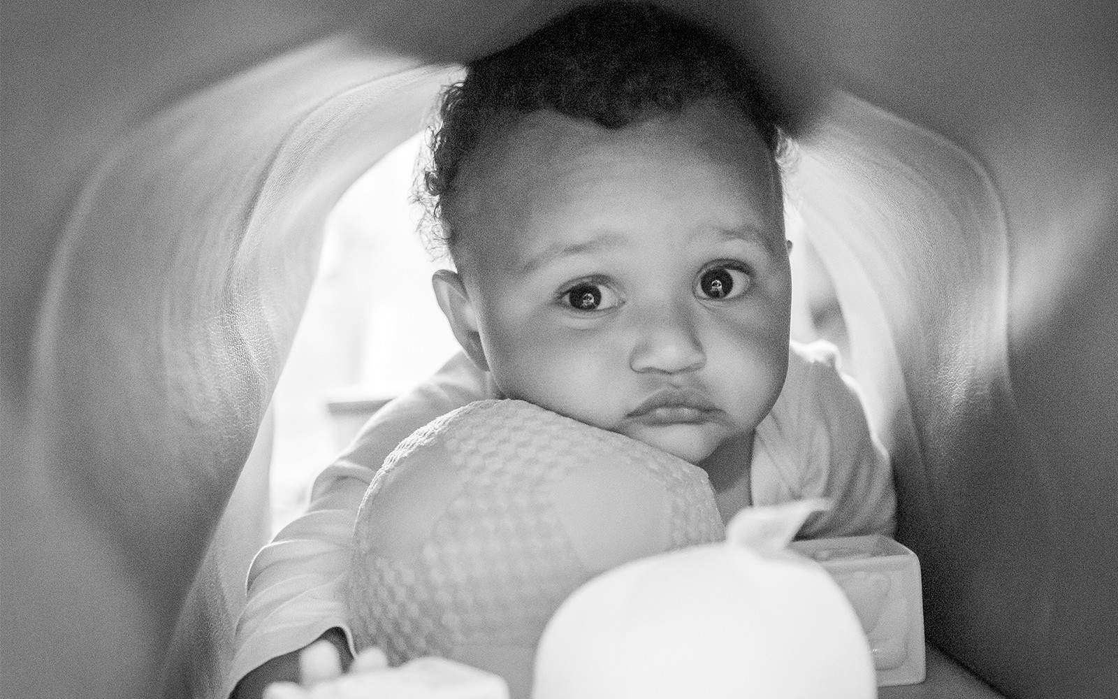 Black and white image of baby with somber face