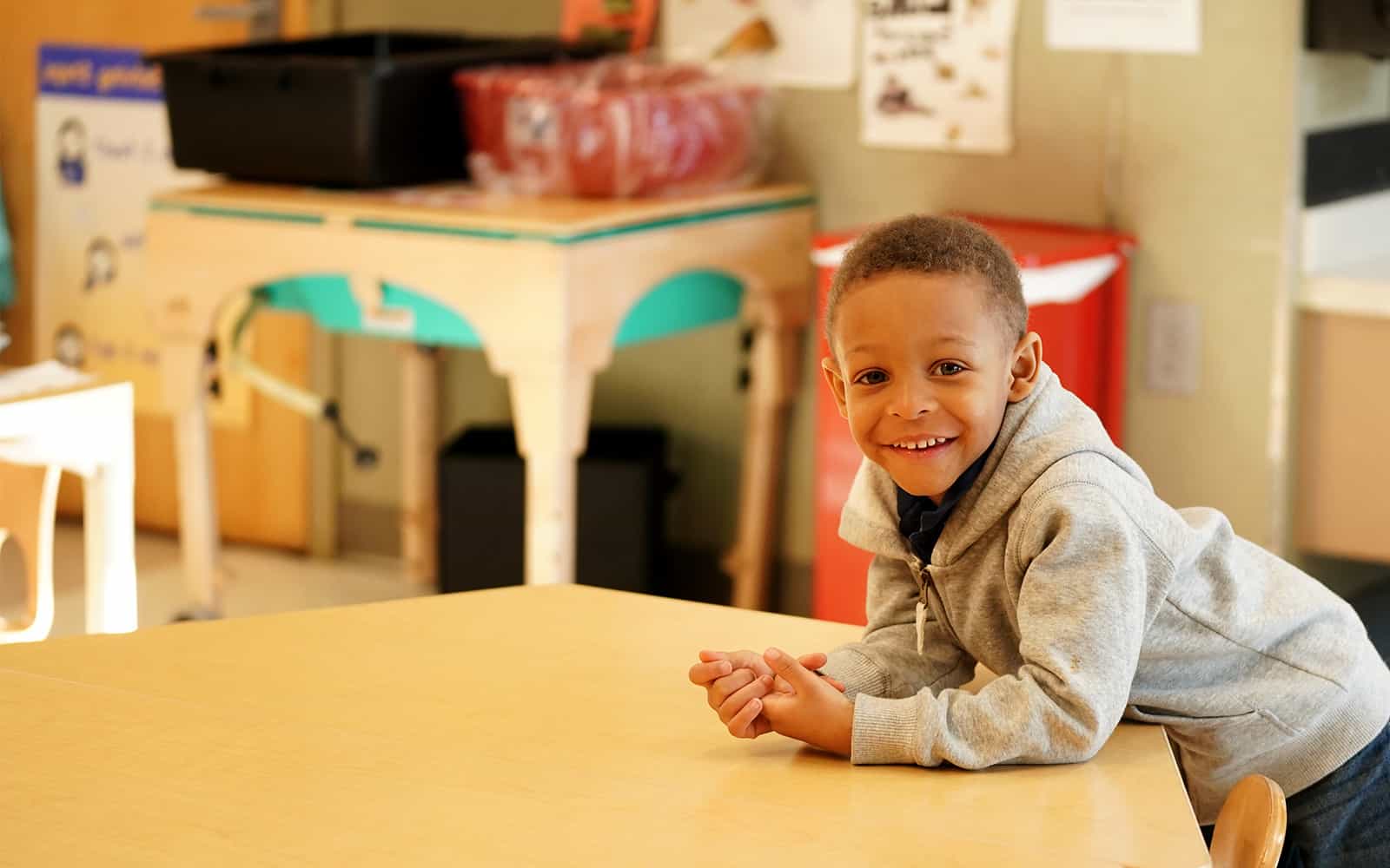 Child leaning over table