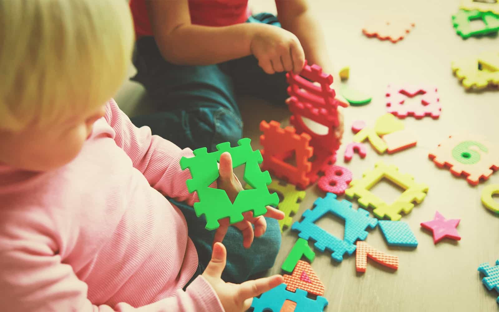 Baby playing with puzzle pieces