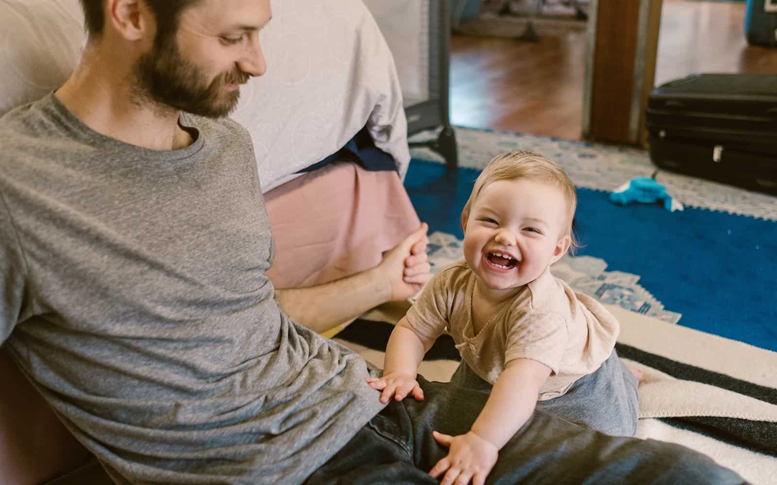 Blonde baby boy playing with his dad