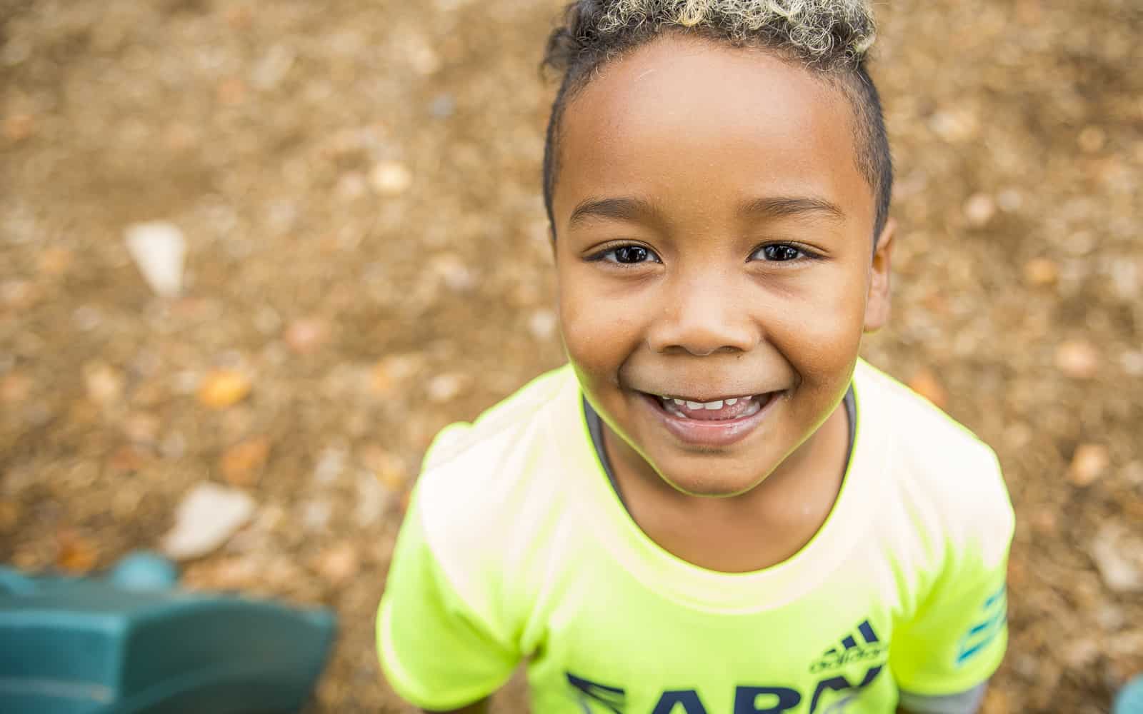 Smiling boy wearing lime colored shirt