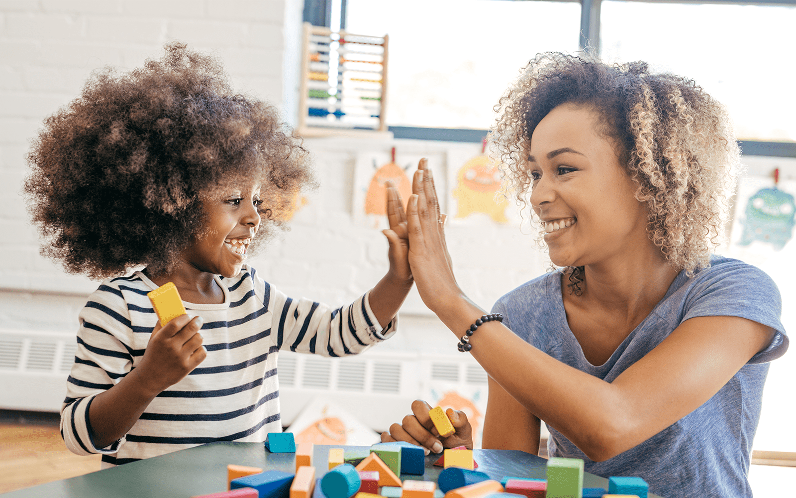 Teacher and girl with blocks