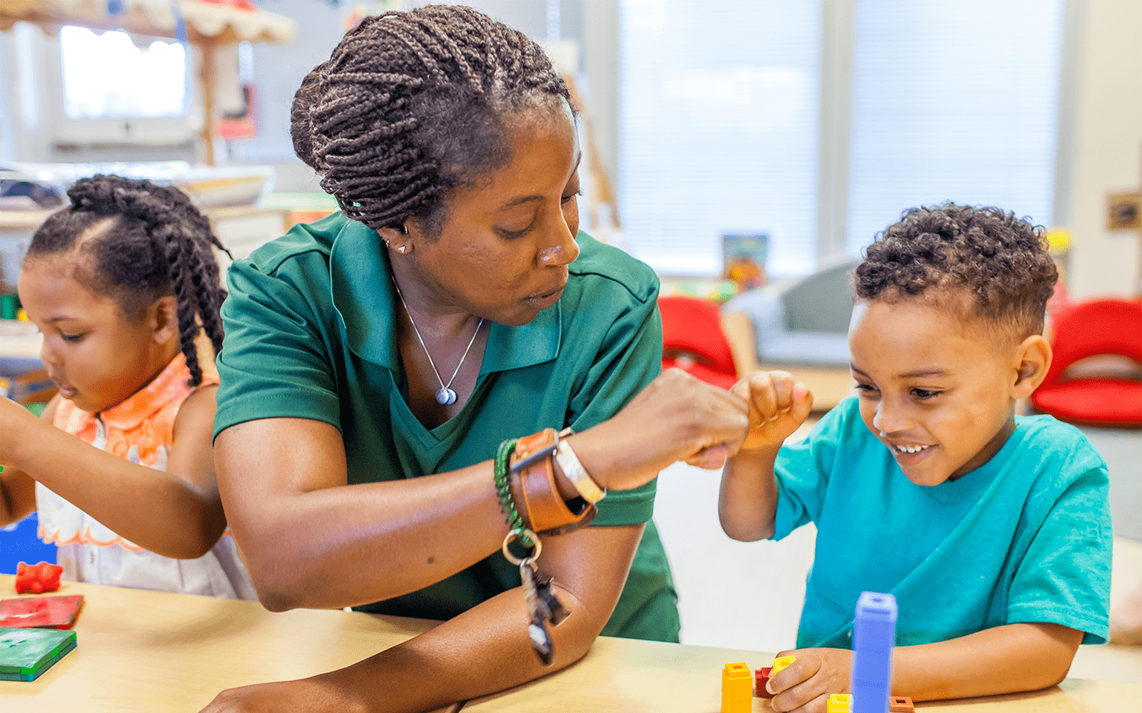 Teacher fist bumps young student