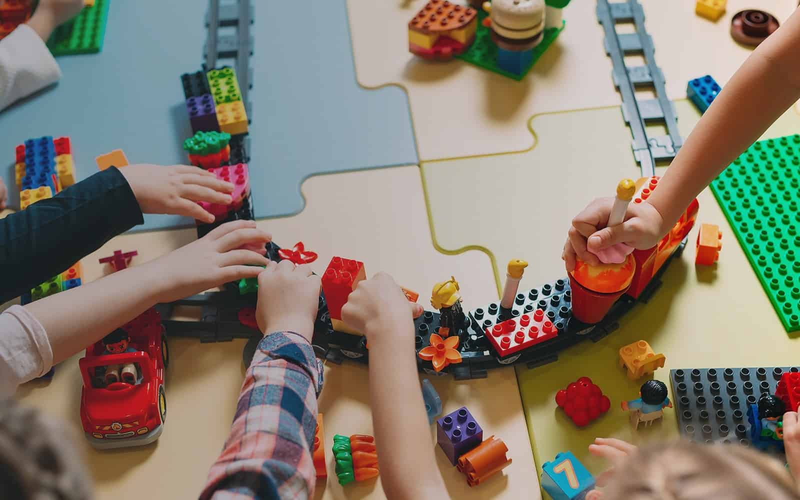 Children planing with Legos at table