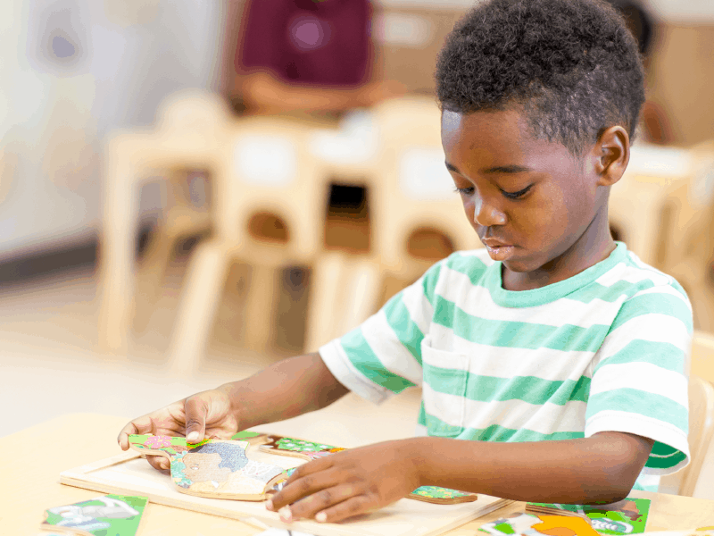 Little boy playing with puzzle