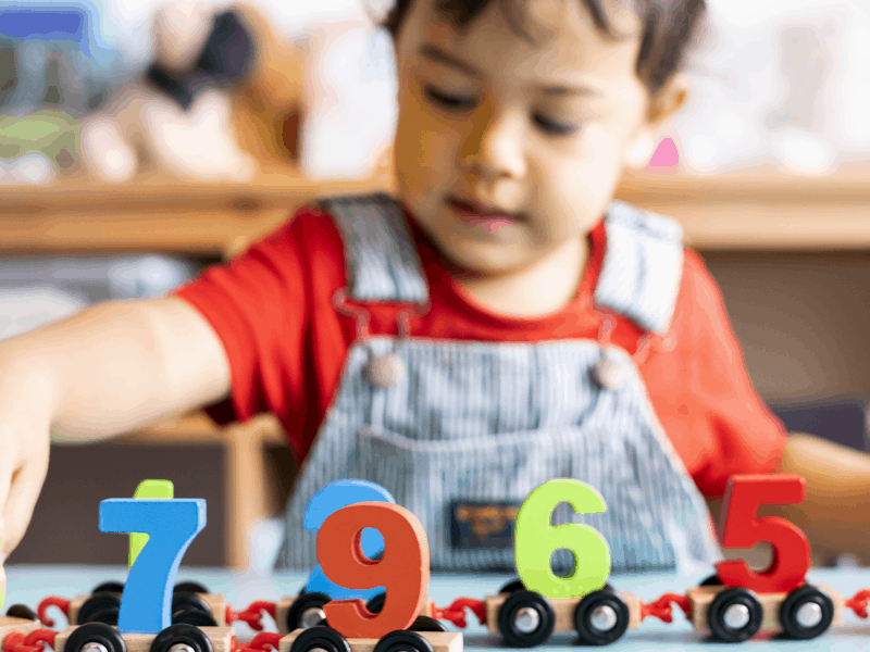 Little boy playing with learning toy