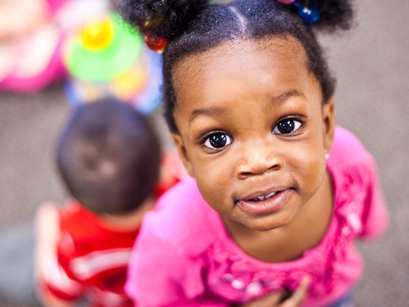 Little girl looking up close at camera