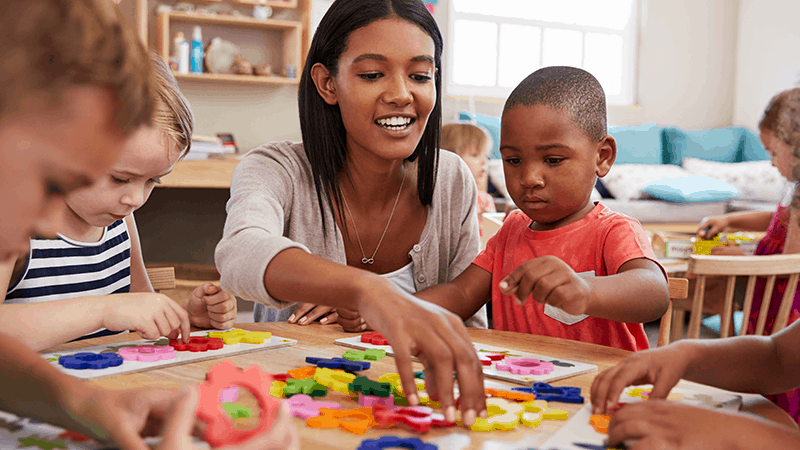 Children playing with teacher