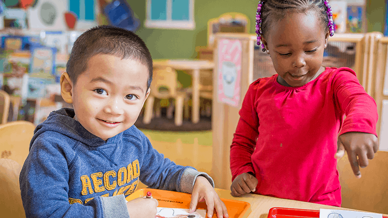 two children coloring together