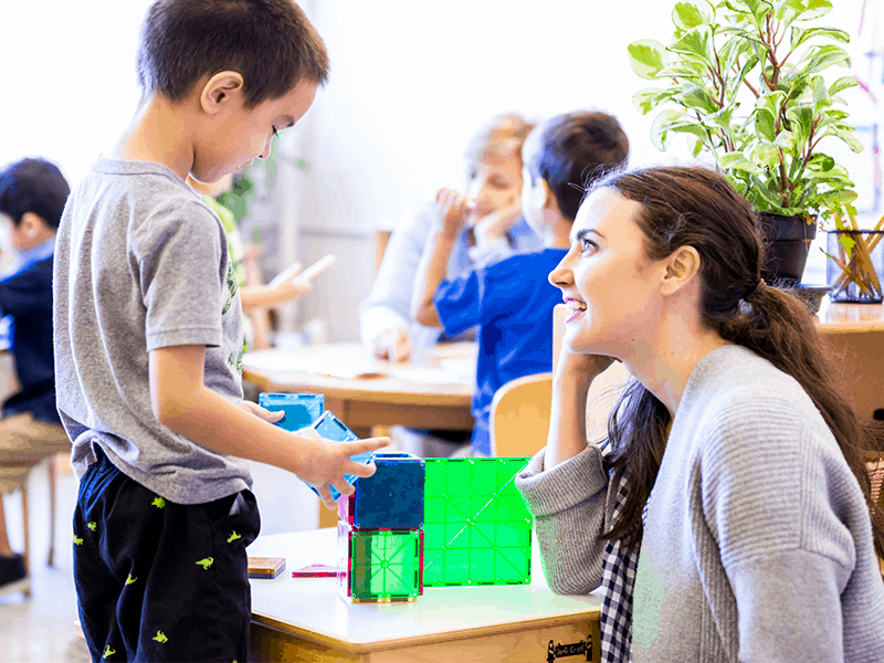 Boy and teacher building blocks