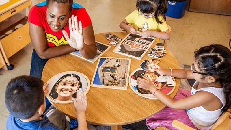 Teacher engaging with three kids