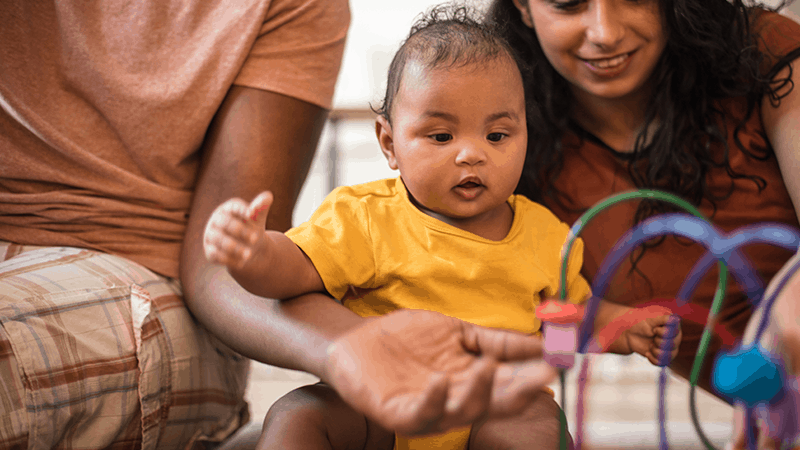 Baby playing with parents