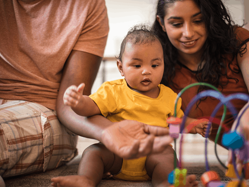 Baby playing with parents