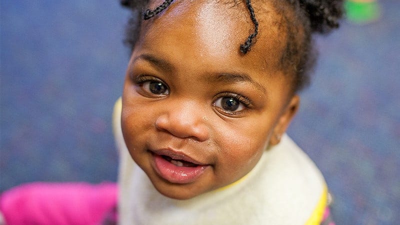 Little girl looking up at camera