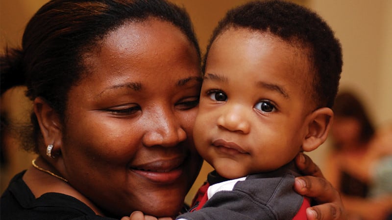 Mother embracing young child