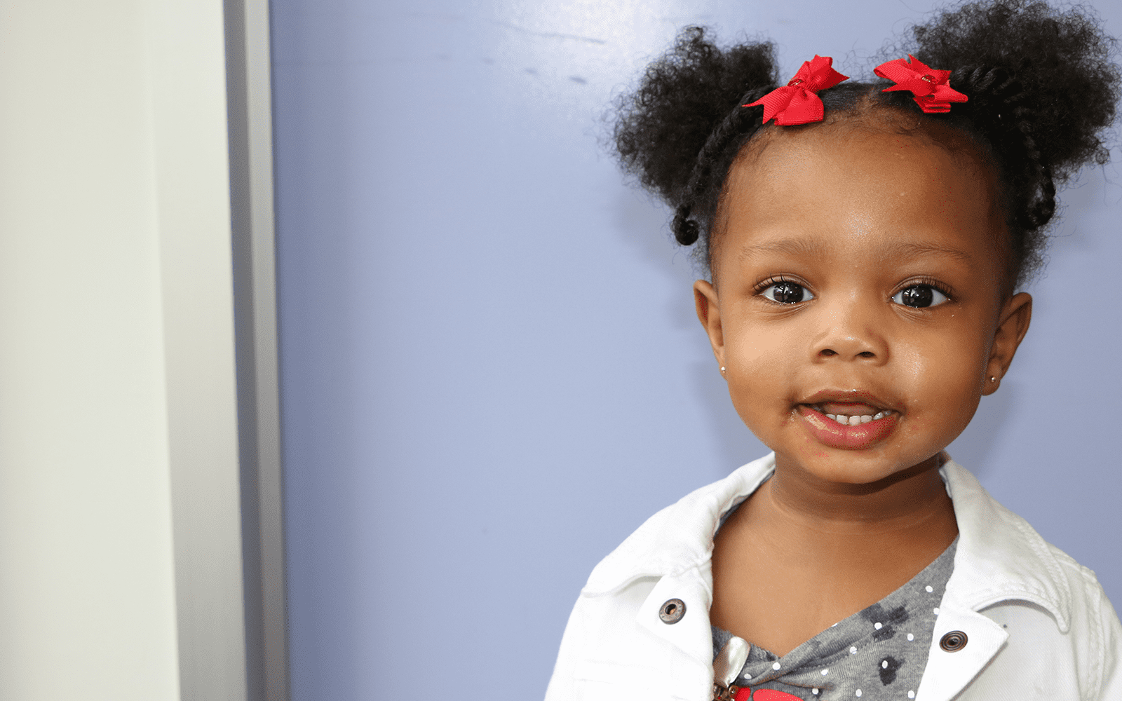 Girl smiling with red bows