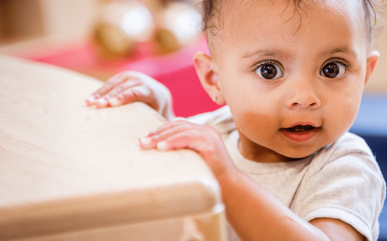 Young child standing against table