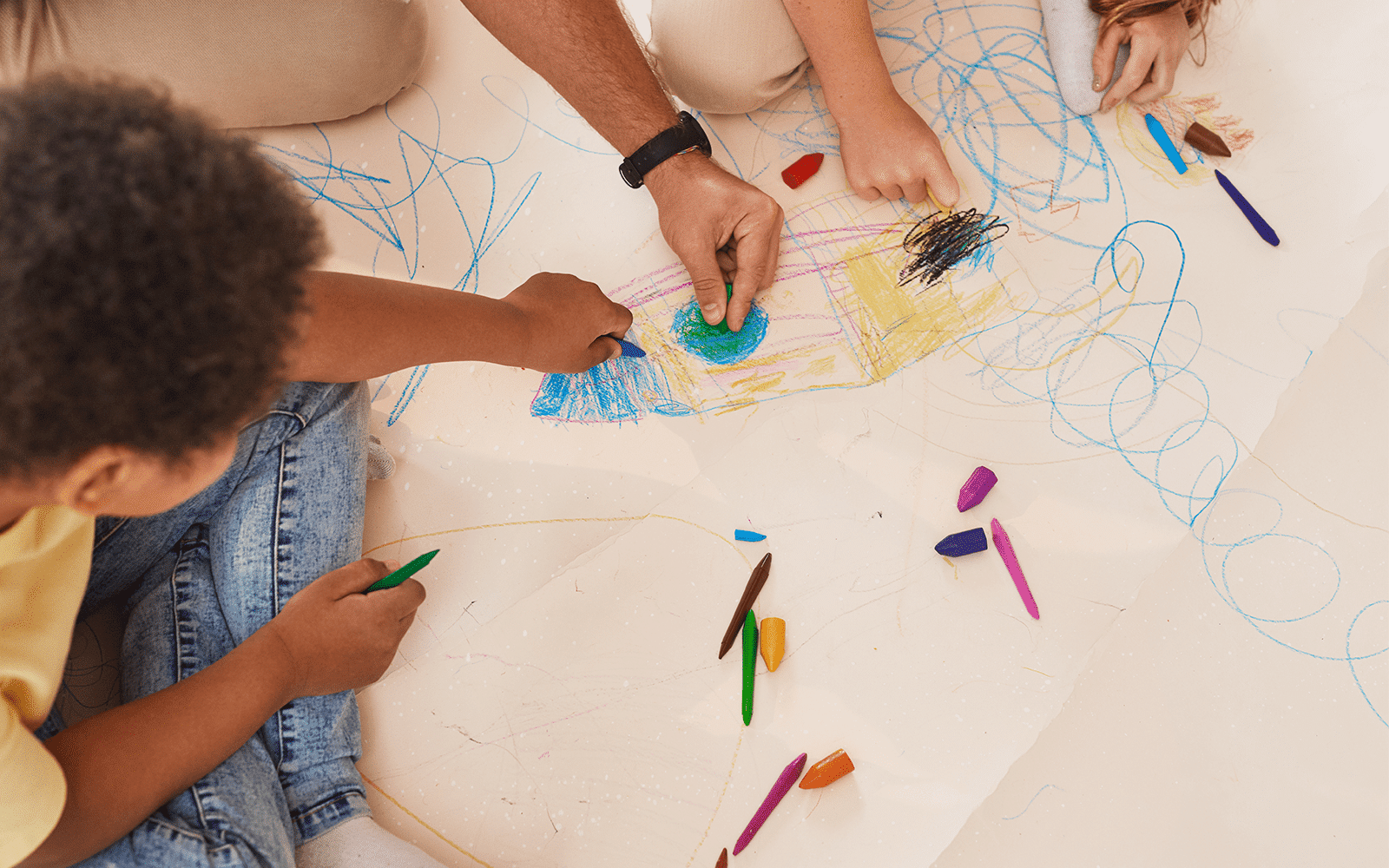 Child Drawing With Teacher Close Up