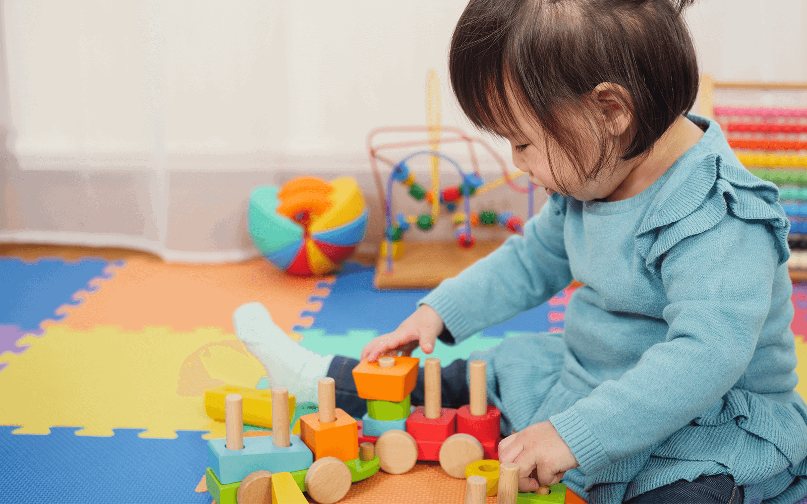 Little Girl Playing with Learning Toys