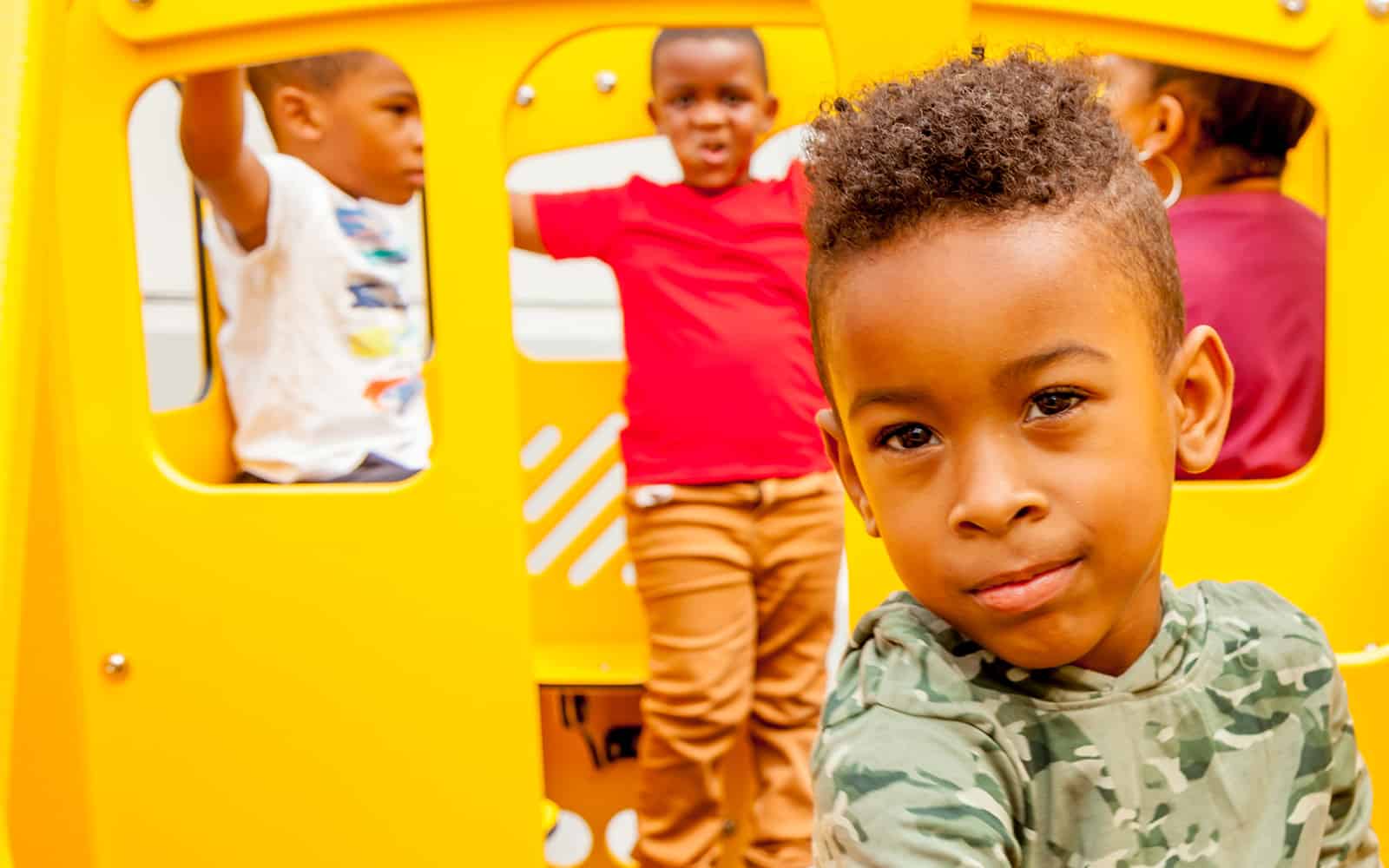 Child playing in school bus on playground