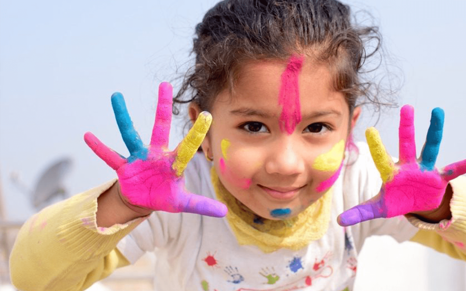 Child holding up painted hands