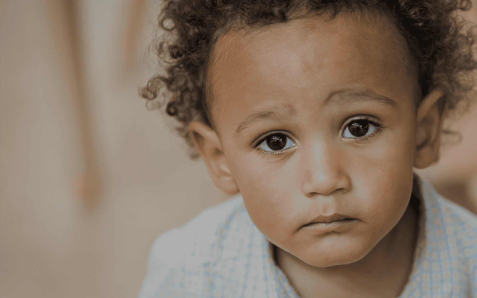 Pensive child looking at camera