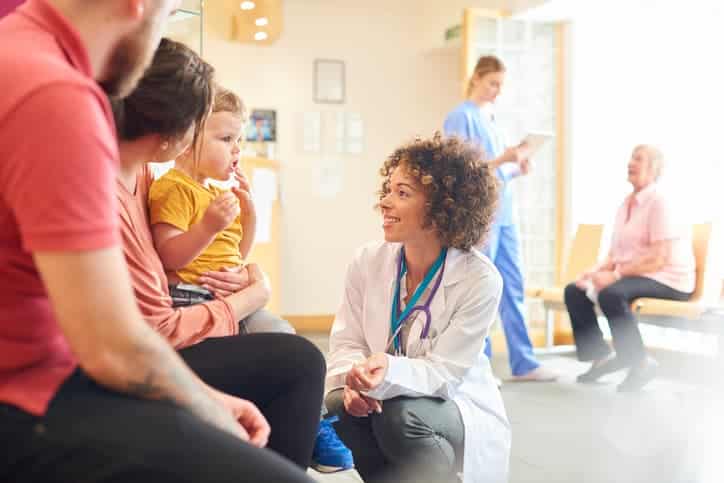 Health provider talking to child and parents