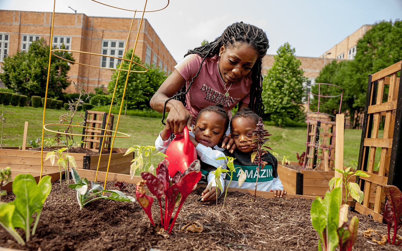 Mom and twins watering garden