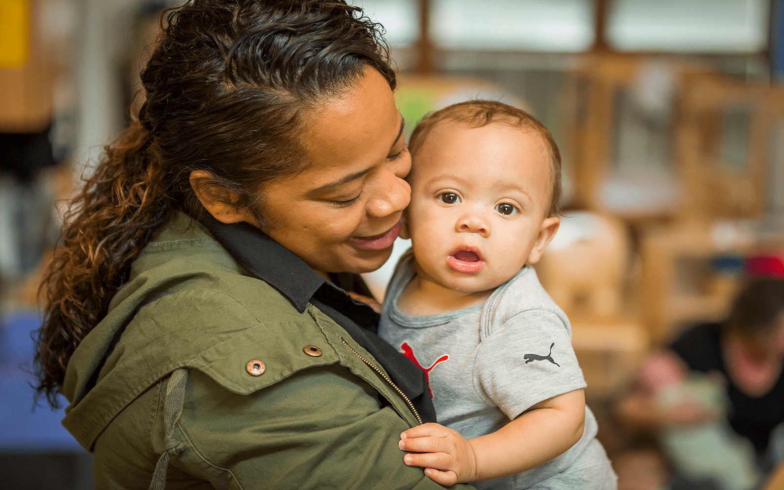 Mom holding curious baby