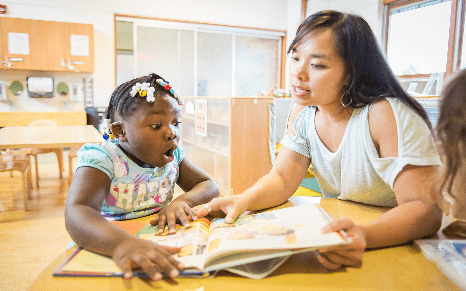 Teacher and shocked girl reading book