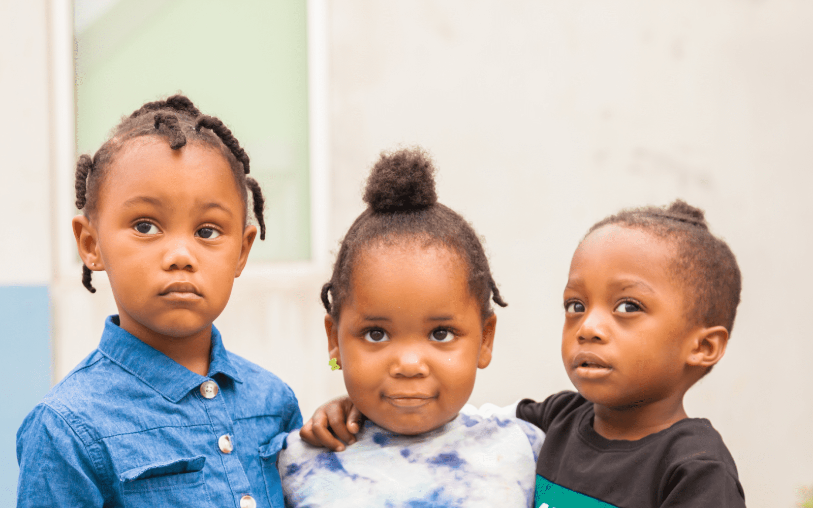 Three kids looking pensive