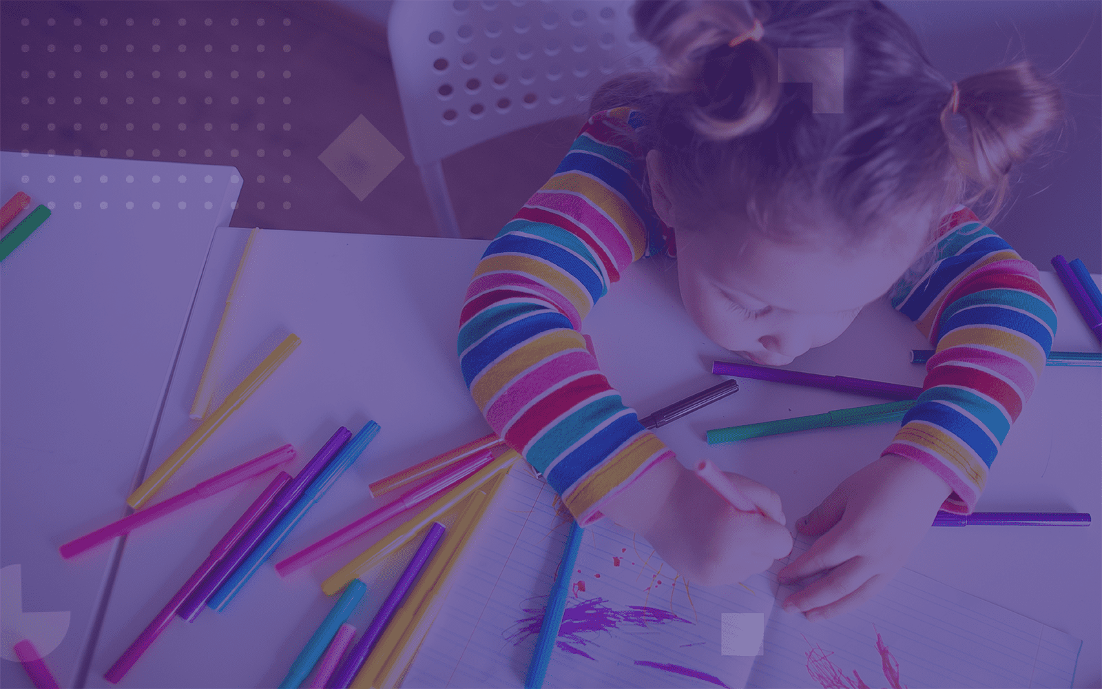 Little girl coloring at a table (purple overlay)