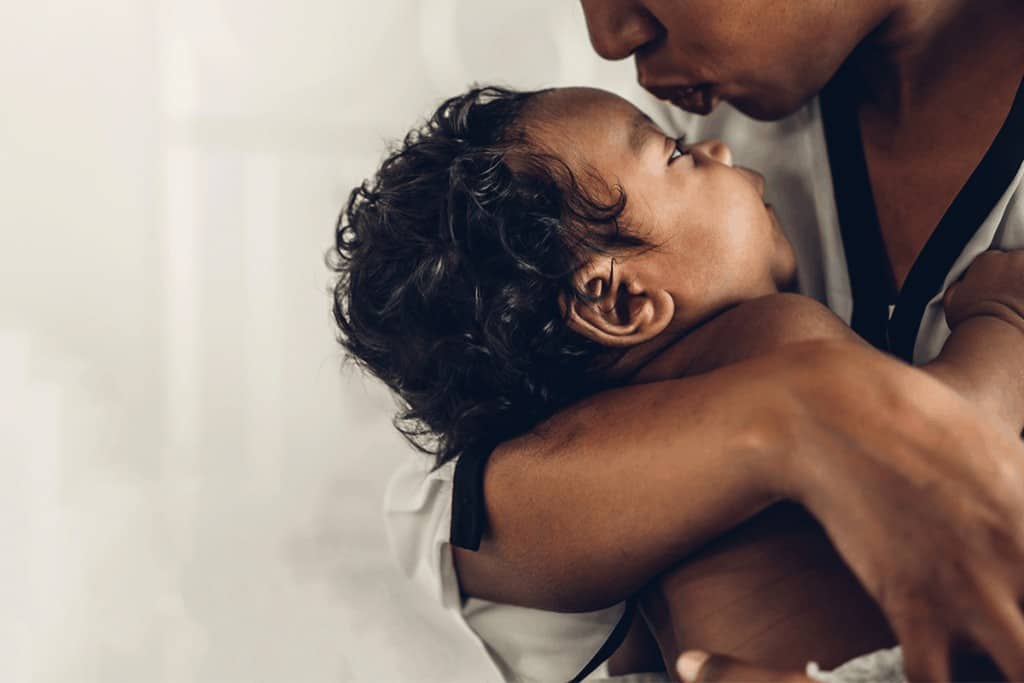 Parent kissing baby