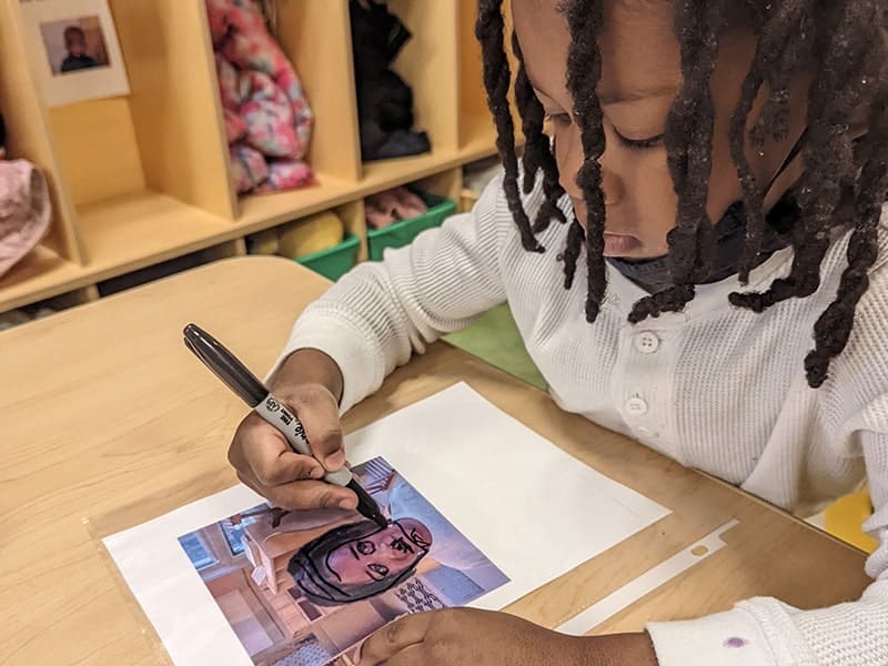 Educare Chicago student tracing photo of himself
