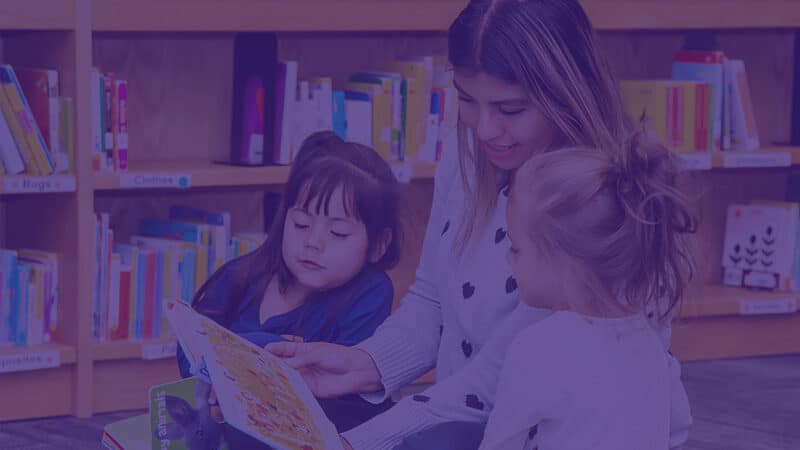 Photo of Educare West DuPage teacher reading to young students