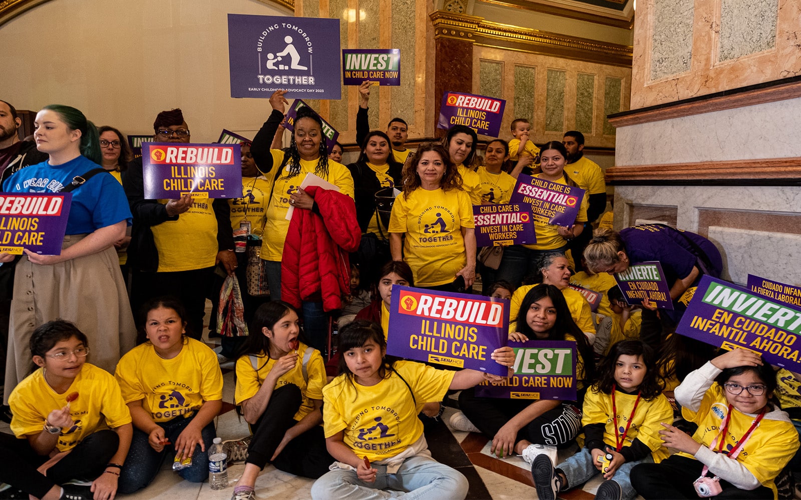 A group of parent advocates and their children in yellow Advocacy Day shirts