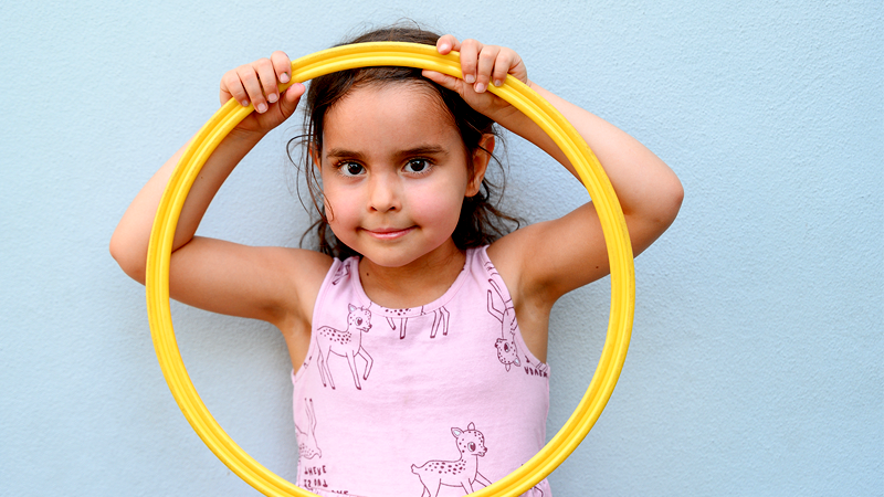 Educare Miami student holding yellow hula hoop