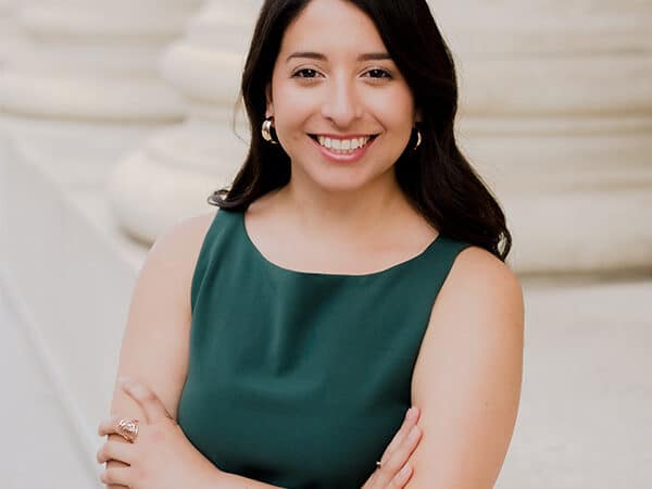 Melissa Maldonado stands in a dark green shirt