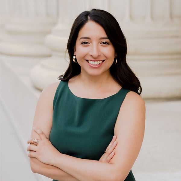 Melissa Maldonado stands in a dark green shirt