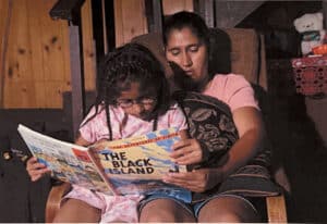 Anna and her mother reading together 