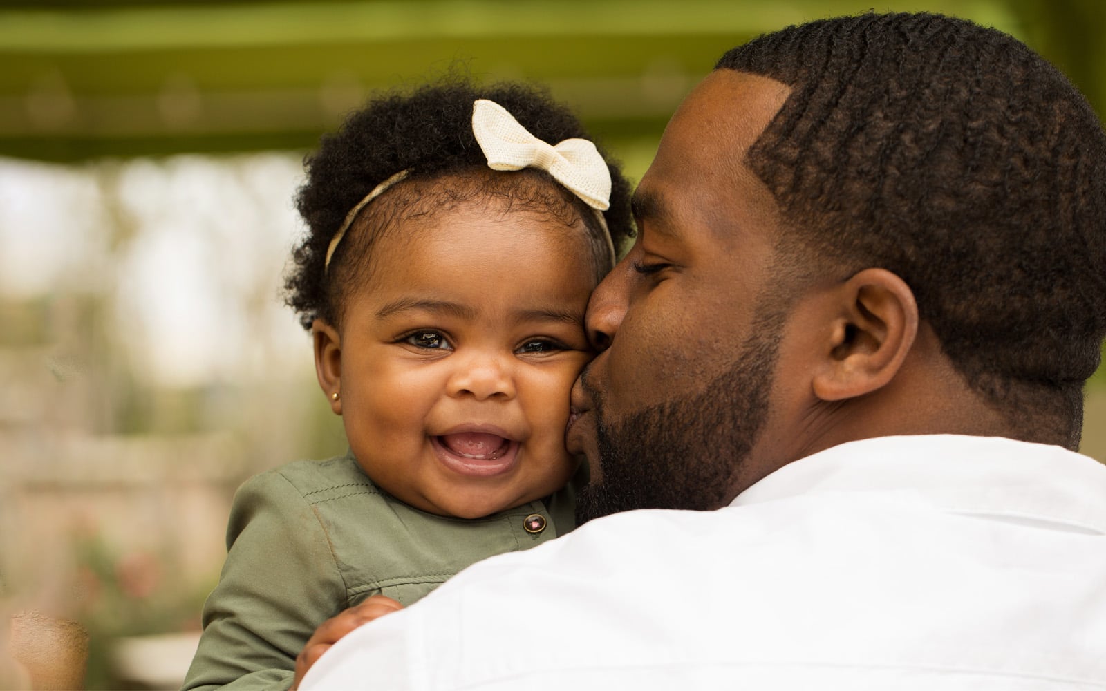 Father kissing daughter on cheek