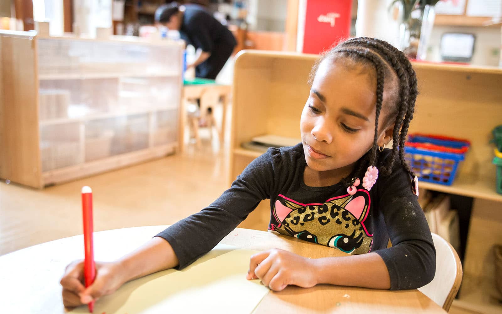 Educare student doing a writing activity at school