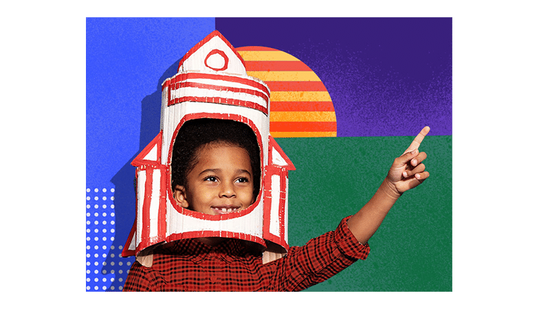 Child in a space ship made out of cardboard pointing their finger