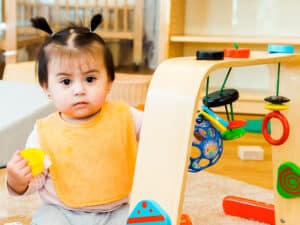 Young child playing with string toy