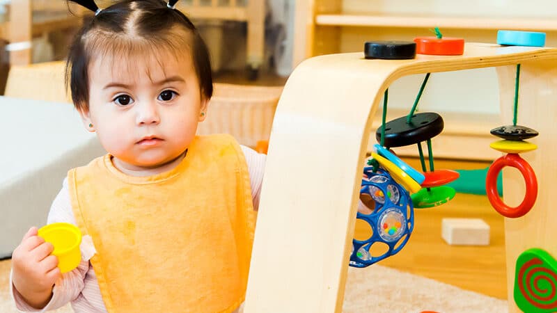 Young child playing with string toy